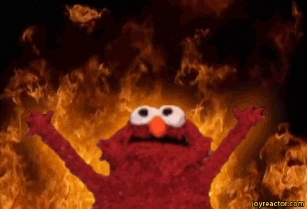 Elmo with his arms raised up and fire behind him